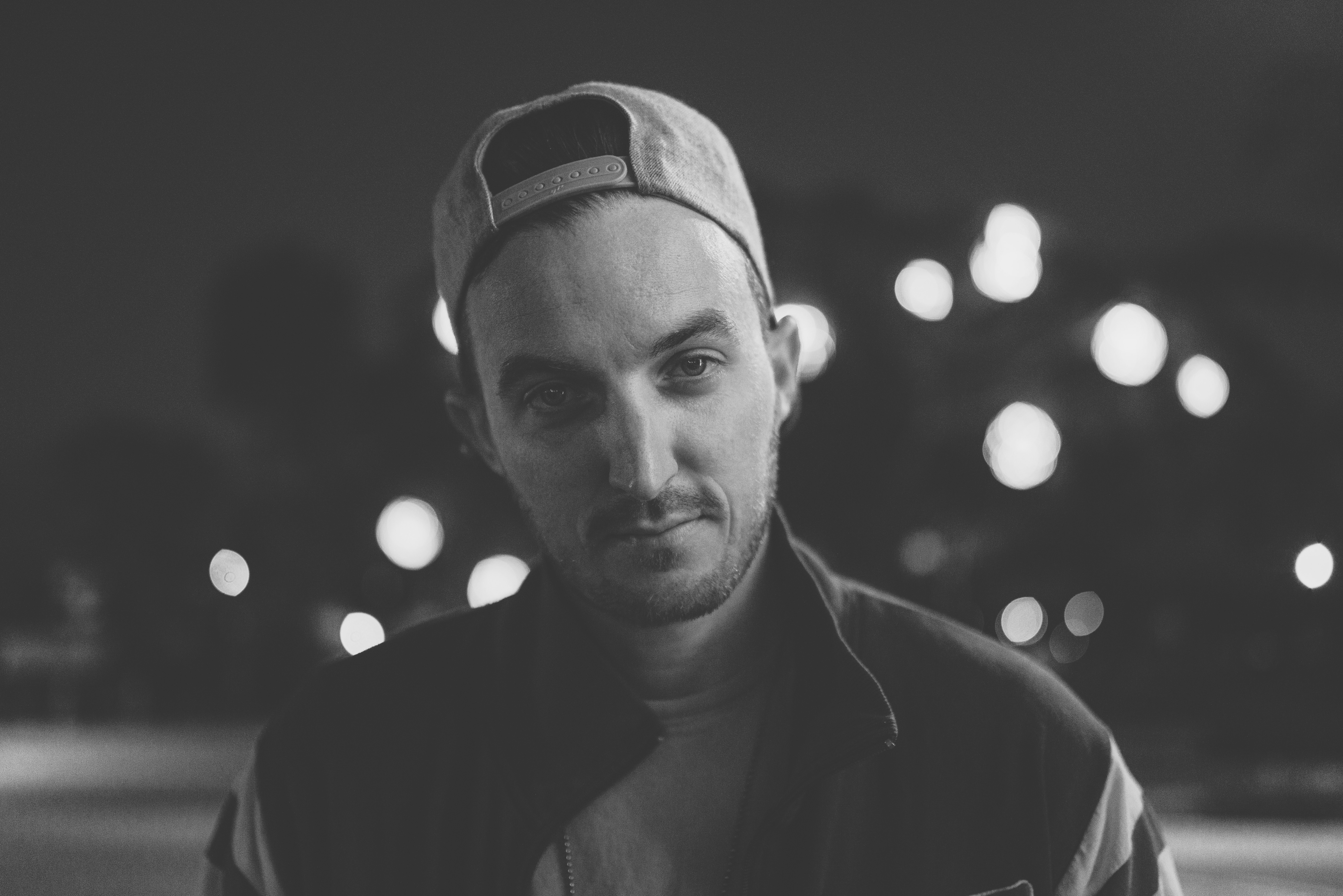 grayscale photography of man with cap